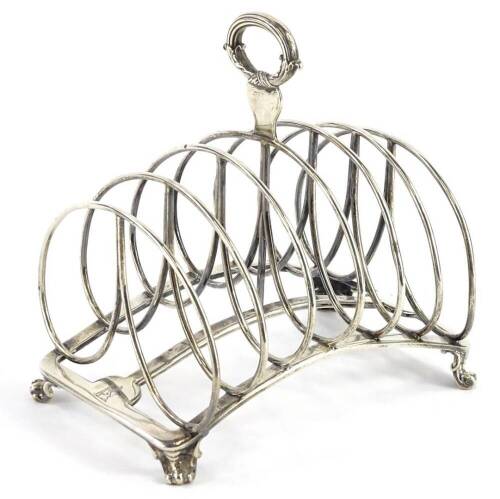 A George IV silver six division toast rack, with reeded and scroll cast handle, concave base and scroll feet, London 1829, by Robert Garrard, 13¾oz, 16cm wide. Provenance: The Estate of Miss Rachel Monson.