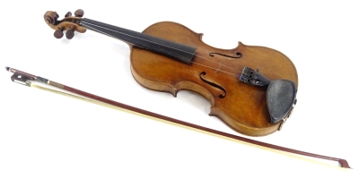 An early 20thC violin, with a one piece back, inlaid ebony roundels and stringing to border, no label, length of back 36cm and a bow.