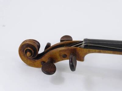 An early 20thC violin, with a one piece back, inlaid ebony roundels and stringing to border, no label, length of back 36cm and a bow. - 5