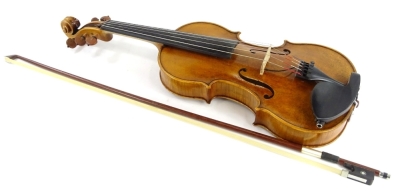 A 20thC violin, with one piece back, length of back 35.5cm and a bow.