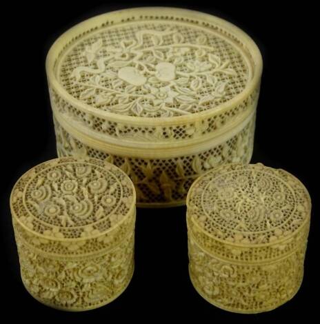 A late 19thC Chinese carved canton ivory box and cover, decorated with flowers, leaves, etc., with fine pierced work to the sides and top, 7cm diameter and two similar smaller examples. Provenance: The Estate of Miss Rachel Monson.