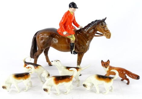 A Beswick model of a huntsman riding a brown horse, five hounds and a small fox (7).