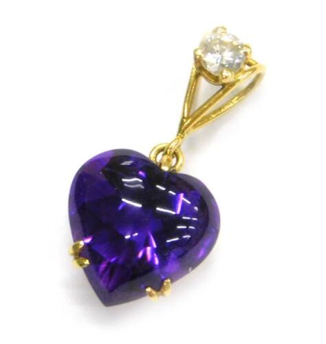 An amethyst and diamond heart shaped pendant, the heart shaped cabochon amethyst 10.5mm x 9.5mm, in yellow metal claw setting, split bail set with a 3.1mm diameter, round brilliant cut diamond, in yellow four claw setting, approx 0.1cts, yellow metal, unm