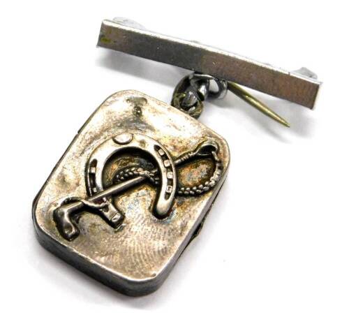 A silver horse related pendant/brooch, the small rectangular silver locket with horseshoe and riding crop, Birmingham assay, on a later single costume pin bar brooch, the pendant 1.8cm x 2.2cm.