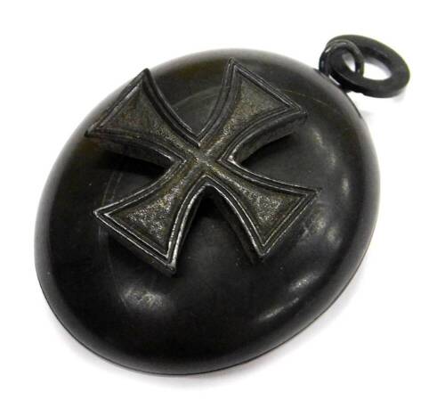 A carved jet locket, decorated to the exterior with a Maltese cross and internally with a bird etc.