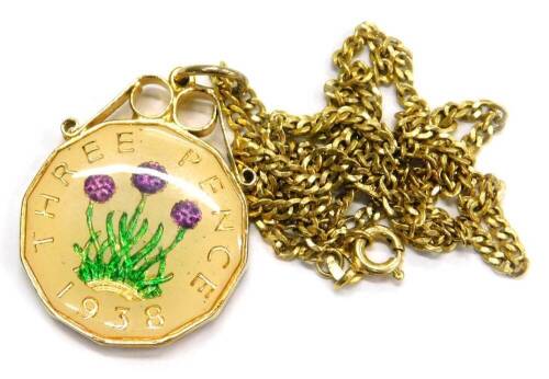 A modern coin pendant and chain, with a three pence piece enamel decorated pendant, in gold plated frame, with a gold plated chain, boxed.