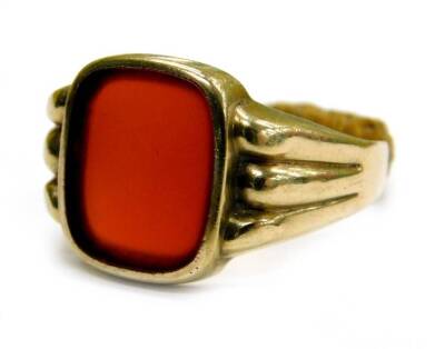 A gent's signet ring, set with rectangular cut red/orange agate, in rub over setting, with a three row design shoulder, yellow metal, marked 333, possible other markings under the homemade ring adjuster, 3.8g all in.