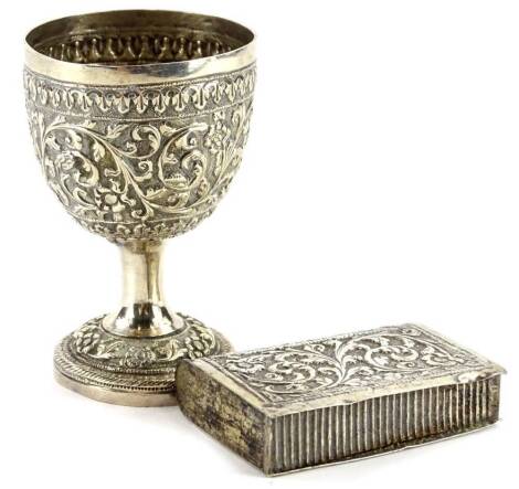 Two items of Eastern white metal, an egg cup embossed and chased with scrolls, flowers, etc. on a tapering base and a similar Vesta case, both unmarked, possibly Indian, 3¾oz. Provenance: The Estate of Miss Rachel Monson.