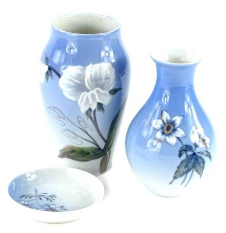Three items of Royal Copenhagen porcelain, to include a vase decorated with a white flower, 15cm, another baluster shaped vase, and a pin tray, differing marks.