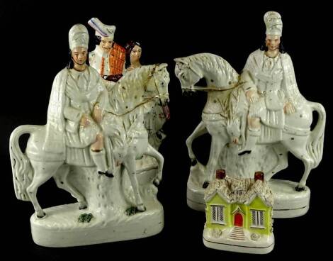 A pair of 19thC Staffordshire flat backed figures, each model in the form of a Scotsman on horseback, a similar flatback watch group and a Staffordshire cottage money box (AF) (4).