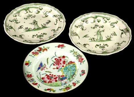 A Chinese famille rose porcelain plate, decorated with flowers, birds, 22.5cm diameter, and a pair of continental faience plates, each decorated with figures, flowers, etc., in green, 25cm diameter.