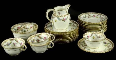 An Aynsley part tea service, decorated with swags of flowers and leaves within gilt borders, printed mark to underside and retailed by Thomas Goode & Co. London.