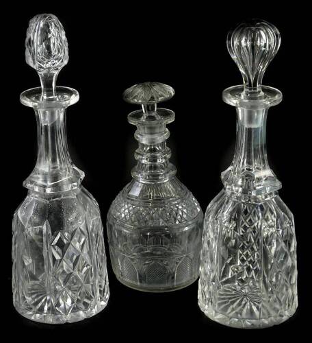 Two similar cut glass decanters, each with a slender neck and associated stopper and a triple ring neck 19thC decanter with mushroom shape stopper (3).