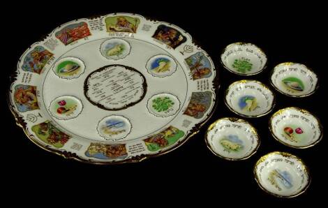 A Royal Cauldon Passover Seder dish, decorated with Egyptian scenes depicting figures relating to darkness, slaying the first born, etc., sold with five matching dishes and details showing the order of performing the ceremony, printed marks to underside,