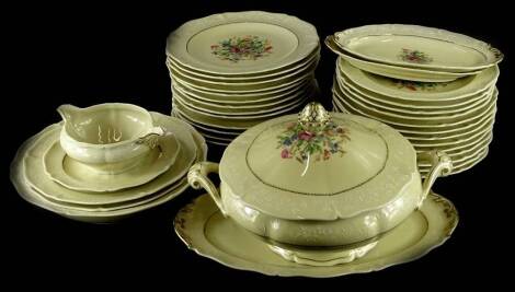 A Royale Limoges part dinner service, printed with wild flowers, on a beige ground with raised decoration in white, the tureen and cover 33cm wide.