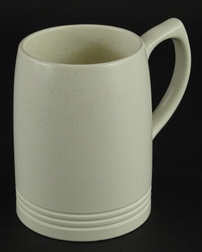 A Keith Murray Wedgwood cream glazed mug, printed marks to underside, 12cm high.