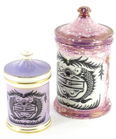 A Grays pottery lustre jar and cover, decorated with a stylised dolphin armorial, 28cm high and a similar Portmeirion smaller jar with a purple glaze, designed by Susan Williams-Ellis (2).