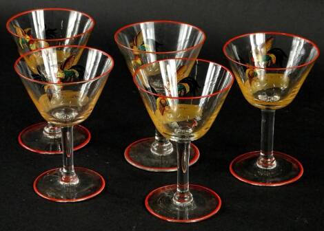 A set of five 1920's/30's cocktail glasses, each decorated with cock fighting scenes.