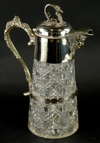 A late 19th/early 20thC cut glass claret jug, with silver plated mount cast with grapes, vines and a Bacchus mask, 31cm high.