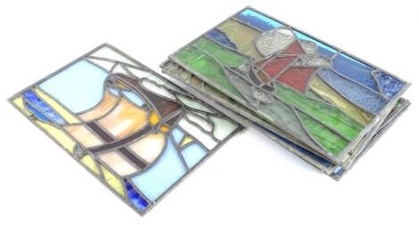 A set of eight late 19th/early 20thC stained glass rectangular panels, each coloured in green, yellow, blue, red and with some opaque marbelised areas, 42cm x 26cm.