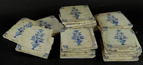 A collection of late 18th/early 19thC Delft blue and white tiles, each decorated with vases of flowers.