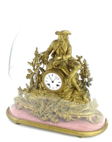 A late 19thC French gilt metal figural mantel clock, the enamel dial with Roman numerals, on a shaped base, decorated with horns, powder flasks, etc., in glass dome, with gilt plinth, (dome AF), 46cm high. Provenance: The Estate of Miss Rachel Monson.