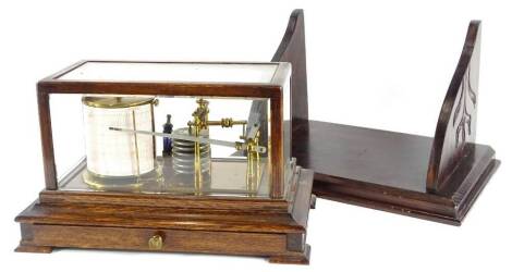 An early 20thC brass barograph, in an oak case with drawer, on bracket feet, 38cm wide and a carved wooden bracket. Provenance: The Estate of Miss Rachel Monson.