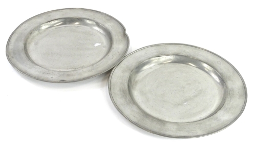 A pair of continental pewter dinner plates, with moulded edges, indistinct touchmarks to underside, 32.5cm diameter.