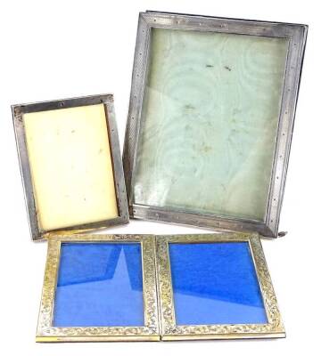 An Edwardian engraved silver mounted photograph frame, Birmingham 1907, 23.5cm x 19cm, another silver mounted photograph frame, 15cm x 11cm and a silver plated double photograph frame (3). Provenance: The Estate of Miss Rachel Monson.