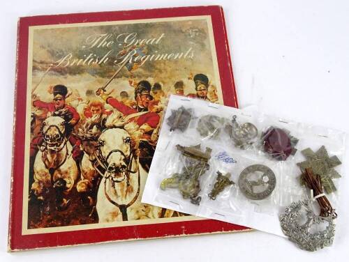 Various cap badges and a book of miniature badges, titled The Great British Regiments.