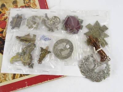 Various cap badges and a book of miniature badges, titled The Great British Regiments. - 2