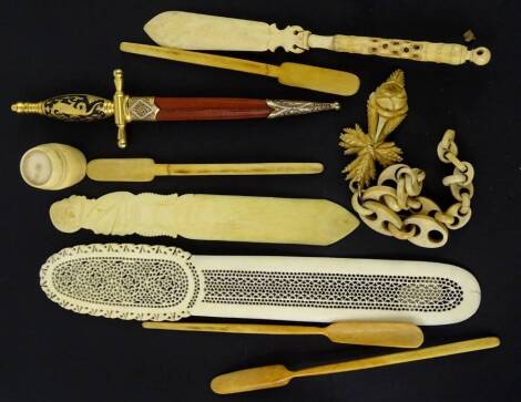 A collection of early 20thC items, to include a pierced and carved ivory page turner, an ivory letter opener with a gentleman carved to the handle, possibly a politician, three bone carved marrow scoops, etc.