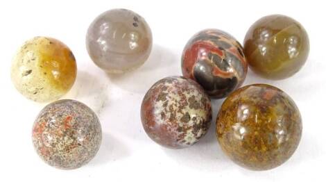 Seven 19thC ceramic and semi precious stone marbles. Provenance: The Estate of Miss Rachel Monson.