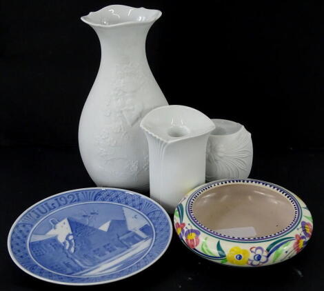 Three items of Kaiser bisque porcelain, to include a baluster shaped vase, a Poole pottery shallow bowl, decorated with flowers and a Royal Copenhagen calendar plate.