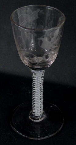 An 18thC wine glass, the tapering bowl engraved with wheat, birds, etc., on an opaque twist stem with plain foot, 13cm high.