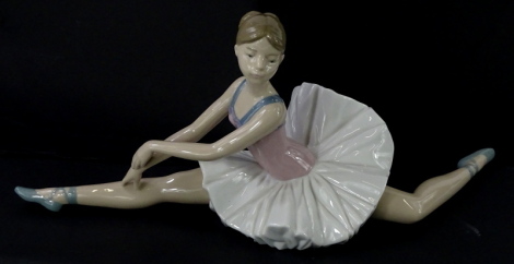 A Nao porcelain model of a seated ballet dancer, 38cm wide.