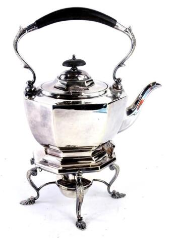 A silver plated tea kettle on stand with spirit burner, with composite handle and knob, the base with cabriole legs and shell cast feet.