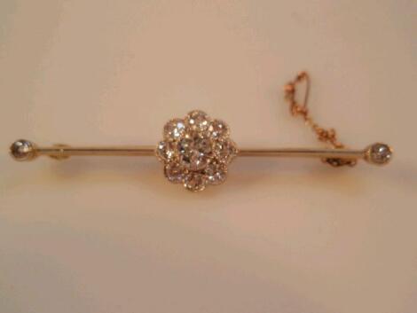 A diamond set floral motif bar brooch