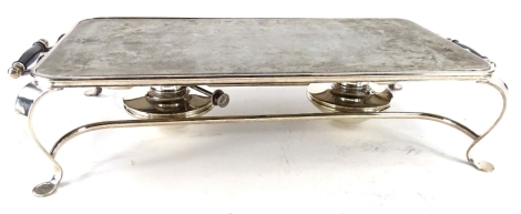 A silver plated rectangular warming plate, with side handles and two burners on shaped legs.