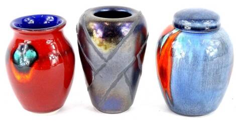 Three Poole pottery vases, to include black lustre glaze example and a ginger jar, each in original box, the largest 10cm high.