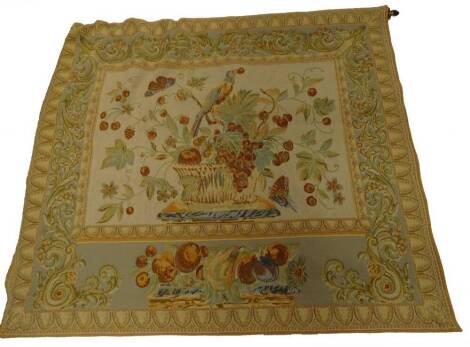 A continental style machine woven tapestry, decorated with a vase of flowers, fruit within geometric borders, etc.