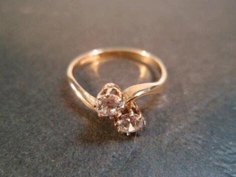 A 9ct gold and white stone crossover ring