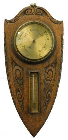 A late 19thC weather station, comprising aneroid barometer and thermometer, on shield shaped carved mount, 51cm high.