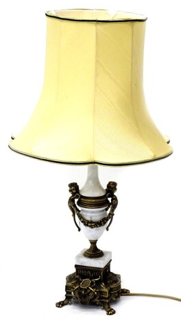 A continental white marble and gilt metal lamp base, decorated with female masks, swags, etc., and a fabric shade 73cm high.