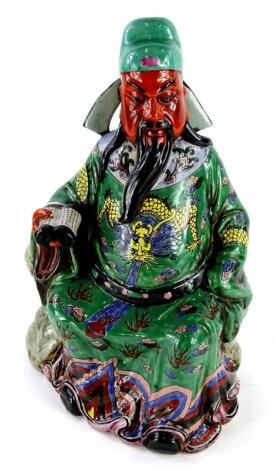 A Chinese porcelain figure of an emperor or immortal, holding a scroll, decorated in yellow, green, blue, purple coloured enamels, unstamped, 43cm high.