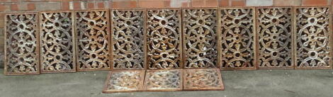 A collection of nine Victorian wrought iron rectangular panels, each decorated with a central wheel design, 53cm x 30.5cm, and three smaller panels, 33cm x 33cm.