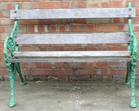 A cast iron two seat garden bench, decorated with flowers, leaves, etc., 119cm wide.