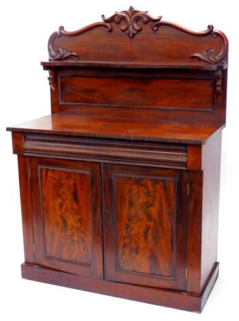 A Victorian mahogany chiffonier, the raised back decorated with shells, leaves, etc., with a single shaped shelf, the base with a frieze drawer, above two panelled doors, on a plinth, 107cm wide.