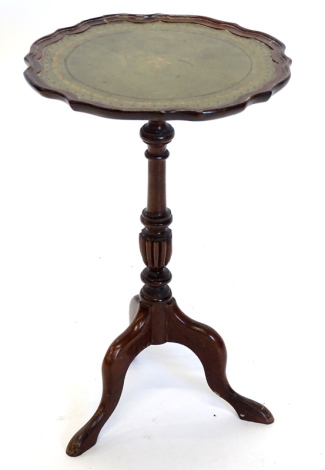 A mahogany wine table, the circular dished top with a shaped edge and green leather inset, on turned and fluted column, and splayed legs, 35cm diameter. Provenance: The Estate of Miss Rachel Monson.