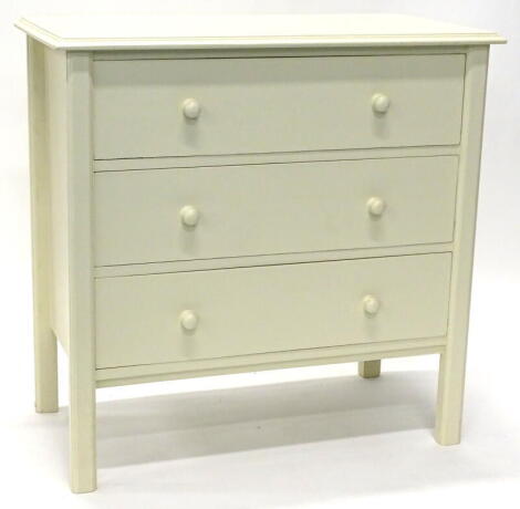 A cream painted chest of drawers, the top with a moulded edge above three legs, each above turned wooden handles, 83cm wide.